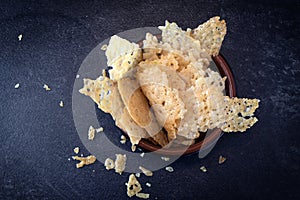 Crisp parmesan cheese chips, homemade party snack in a bowl on a