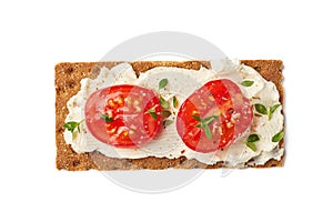 Crispbread with cream cheese and tomato slices on white