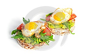 Crispbread sandwich with guacamole, arugula, tomatoes and quail egg isolated on a white background. Bruschetta with