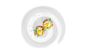 Crispbread sandwich with guacamole, arugula, tomatoes and quail egg isolated on a white background. Bruschetta with