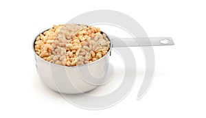 Crisped rice breakfast cereal in a measuring cup