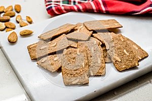 Crispy Almond Thins Cookies / Wafer with Nuts on Marble Board