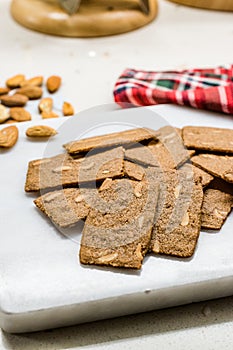 Crispy Almond Thins Cookies / Wafer with Nuts on Marble Board