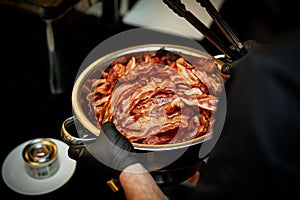 Crispy Bacon: glistening texture of dry cooked bacon in a chef hands