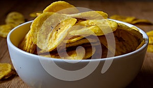 Crispy banana chips in a bowl. Common Indian savory item