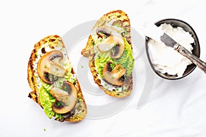 Crispy bread slices with cottage cheese, green lettuce leaves, fried champignon wedges. The appetizer is a simple