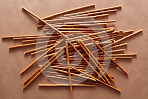 Crispy bread straw on brown paper background