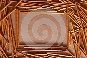 Crispy bread straw on brown paper background