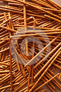 Crispy bread straw on brown paper background