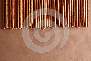 Crispy bread straw on brown paper background