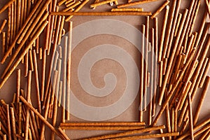 Crispy bread straw on brown paper background