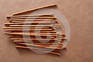 Crispy bread straw on brown paper background