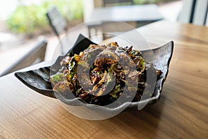 crispy and browned brussel sprouts appetizer at fine dining restaurant with seasoning