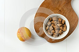 Crispy cereal and chocolate pillows with milk. brakefast with chocolate pillows and peach on white andwooden background