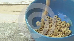 Crispy cheerios into the bowl for the morning a delicious Breakfast Slow motion