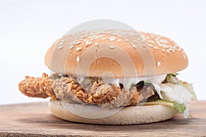 Crispy chicken burger with lettuce, cheese, and mayonnaise