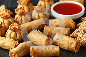 Crispy Chicken wontons, vegetable spring rolls and prawn toasts with sweet chilli sauce. chinese selection. fast food.