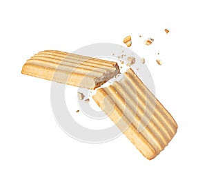 Crispy cookies broken into two halves in the air close up isolated on a white background