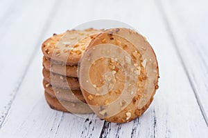Crispy crackers with peanut stack up on white wood