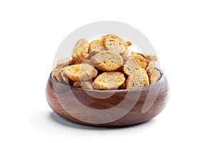 Crispy croutons in wooden bowl isolated on white background