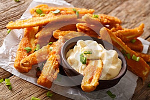 Crispy deep fried baby corn with sauce close-up. horizontal