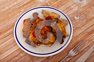 Crispy deep fried chicken wings served on plate