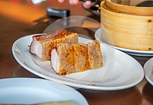 Crispy delicious pork on white dish in Chinese style restaurant