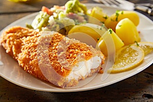 Crispy fresh breaded fish with potatoes photo
