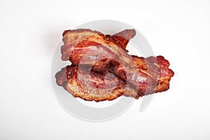 Crispy fried bacon isolated on a white background.