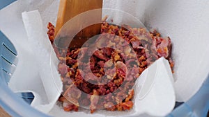 Crispy fried bacon rashers draining on plate with napkin