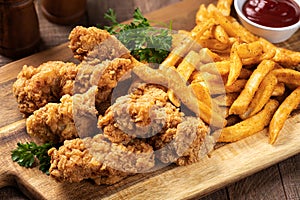 Crispy fried chicken tenders and french fries