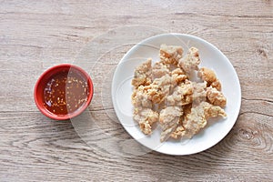 crispy fried Korean chicken with bread crumb and egg yolk on plate dipping barbecue sauce