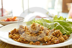 Crispy fried minced catfish with green mango salad and sauce