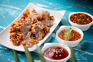 Crispy fried sliced belly pork with spicy sauce