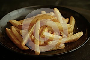 Crispy Golden French Fries in a Dark Bowl