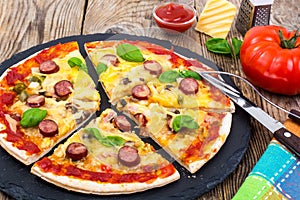 Crispy hot pizza on old wooden table