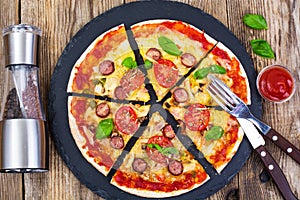 Crispy hot pizza on old wooden table