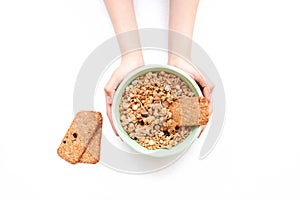 Crispy muesli dry Breakfast in a bowl in hands isolated on white background selective focus, top view