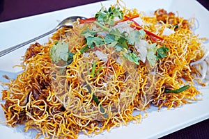 Crispy noodles on white dish, Thai food