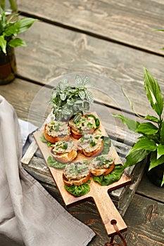 Crispy open-face sandwiches with mutabal topping on the cutting