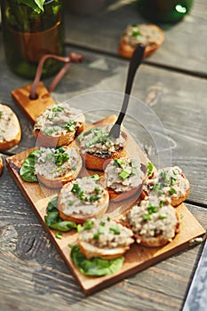 Crispy open-face sandwiches with mutabal topping on the cutting