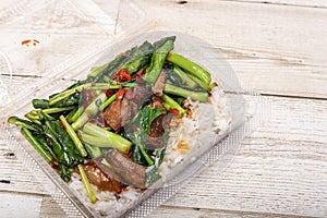 Crispy pork belly on topped rice - Asian food style.Asian street food on wooden floor, Thai food