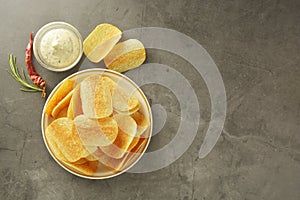 Crispy potato chips with delicious sauce. Top view. Copy space