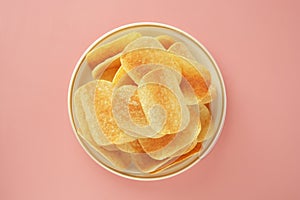 Crispy potato chips isolated over pink background. Top view. Copy space