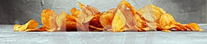 Crispy potato chips. Paprika chips on table. Spicy crunchy chips