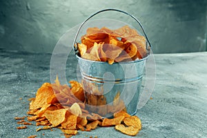 Crispy potato chips. Paprika chips on table. Spicy crunchy chips