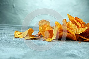 Crispy potato chips. Paprika chips on table. Spicy crunchy chips