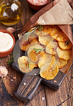 Crispy potato chips. Slices of potato, roasted with sea salt and rosemary.