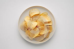 Crispy Potato Chips on a White Plate Top View