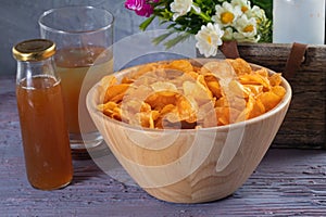 Crispy potato chips on wooden bowl